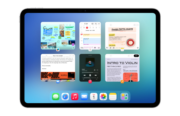 En iPad i vandret position viser flere apps som Kalender og Musik i seks vinduer i to rækker, så alle vinduer vises lige tydeligt.